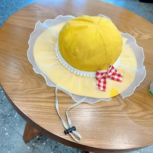 Cute baby girl bucket hat with pearl trim, white mesh ruffle, and red plaid bow for spring.
