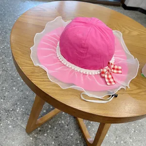Pink children sun hat with mesh ruffle, pearl detail and bow for cute spring daily wear.