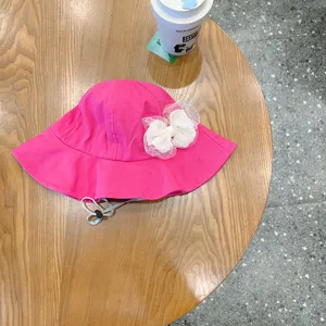 Cute pink baby sun hat with white lace bow and adjustable chin strap for lovely girls outdoor.