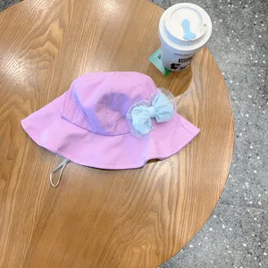 Cute purple bucket hat for kids with light blue lace bow, stylish infant sun protection hat.