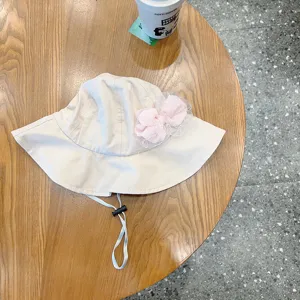 Cute baby bucket hat with pink mesh bow and adjustable chin strap. Perfect sun protection for girls.