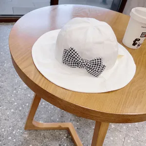 Cute white baby sun hat with black and white houndstooth bow, cotton fisherman hat for little girls.