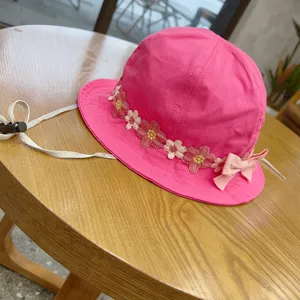 Details of the cute pink children bucket hat with floral embroidery and adjustable strap.