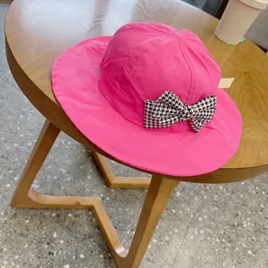 Children pink sun bucket hat detail, cute houndstooth bow knot decoration, cute style.