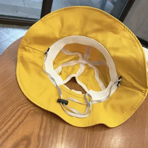 Yellow toddler bucket hat interior detail showcasing adjustable chin strap and breathable lining