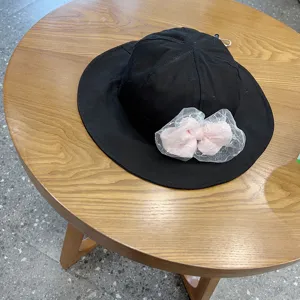 Cute children sun bucket hat with pink mesh bow, breathable black cotton hat for little girls.