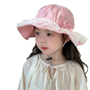 Cute pink baby sun hat with white lace trim and bow for toddler girls summer outdoor.