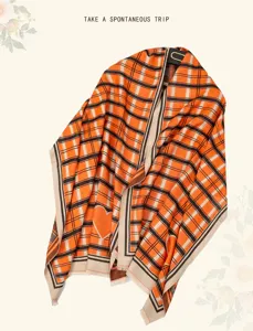 Orange plaid scarf with heart pattern, cozy knitted winter shawl and fashion accessory.