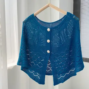 Blue hollow-out knit cape detail, elegant pearl buttons, delicate openwork pattern design.