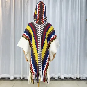 Ethnic style knitted hooded poncho cape with colorful zigzag pattern and fringe hem for women.