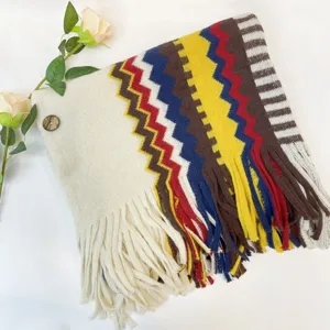 Close-up detail of the vintage ethnic knit shawl showing colorful zigzag patterns and fringe.