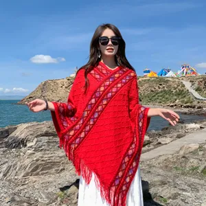 Ethnic style red knitted poncho shawl with fringe for women, perfect for travel and outdoor.