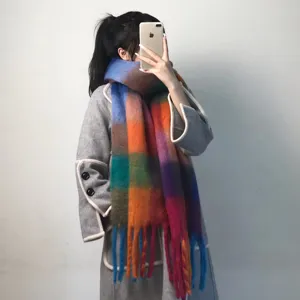 Close-up of colorful plaid scarf detail, showing soft warm fabric and vibrant stripe design.