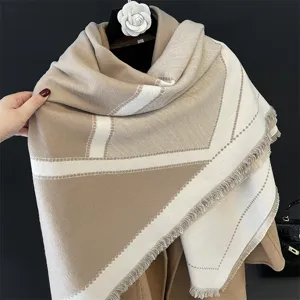Detailed view of winter cashmere-feel oversized scarf with geometric pattern and soft fringe.