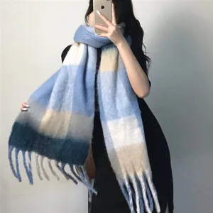 Detailed close-up of the thick colorful plaid scarf showing soft textured loop yarn and fringes.