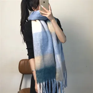 Detail view of the cozy colorblock plaid thick warm winter scarf with soft fringe.