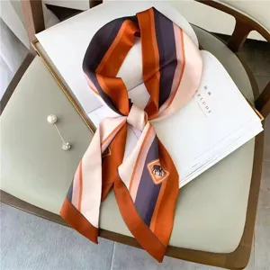 Silk scarf with striped design, elegant neck accessory, luxurious style, fashion accessory.