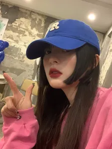 Blue baseball cap for women with white R letter patch, stylish casual cotton headwear.