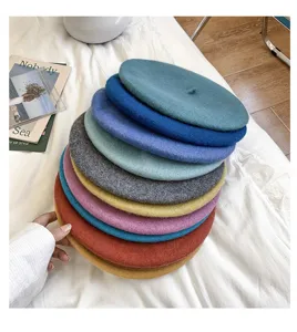Colorful wool beret hats detail stack, soft winter painter caps for women, fashion headwear.