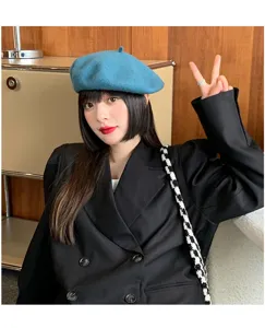 Close-up detail of the stylish blue wool beret worn in a retro indoor scene, elegant texture.