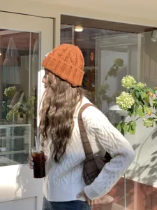 Detail view of a cozy caramel knit beanie hat, perfect for autumn and winter daily wear.