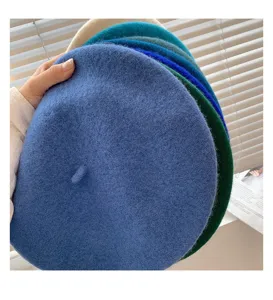 Detailed view of women's wool beret, classic winter retro painter hat in multiple colors.