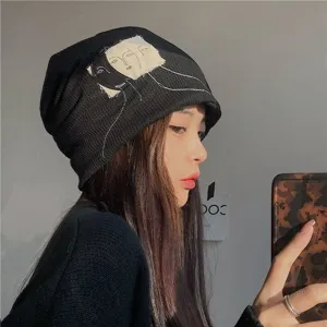 Japanese retro black slouchy beanie hat for women, unique artistic face embroidery design.