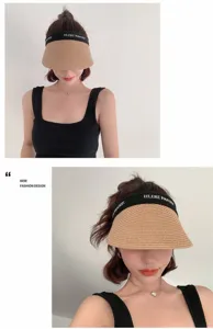 Detailed shot of a stylish straw sun visor hat with a black band, ideal for summer outdoor use.