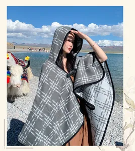 Detailed view of women's gray plaid hooded cloak shawl, perfect for outdoor travel photography.