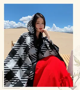 Close-up of the women's hooded knit shawl in a scenic outdoor desert travel setting.