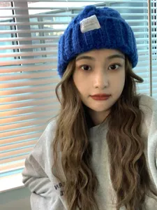 Cozy blue knit beanie hat paired with a casual grey sweatshirt, perfect stylish autumn winter wear.