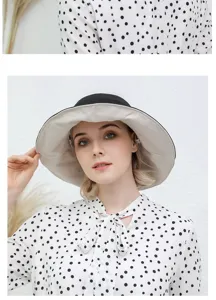 Detail view of the stylish double-sided wide brim sun bucket hat worn by model.