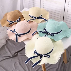 Women large brim straw hat with navy blue bow, stylish summer beach sun protection hat.