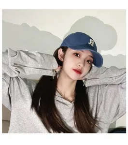 Vintage washed cotton baseball cap and stylish hoodie set with unique zipper details.