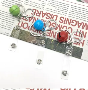Metal bell keychain and bag connector with clear strap, colorful DIY luggage hardware accessory.