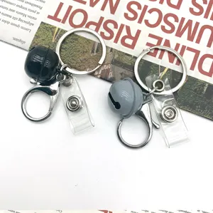 Metal bell keychain set detail, black and grey dog clip keyring, bag charm accessory.
