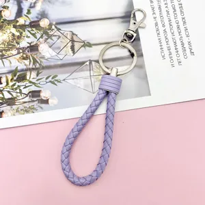 Colorful braided leather rope keychain with metal ring and clasp for keys and bags.