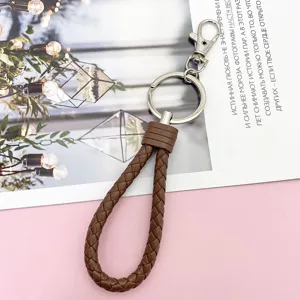 Brown braided leather keychain detail, metal keyring and clasp, premium everyday carry accessory.