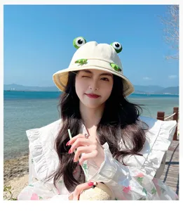 Cute frog bucket hat detail shot, summer sun protection beach hat for women, beige casual style.