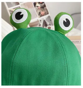 Close-up detail of cute green frog bucket hat, summer sun protection casual casual hat style.