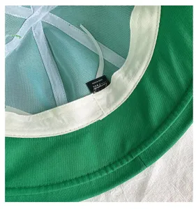 Green bucket hat interior detail with breathable mesh lining and white sweatband for summer.
