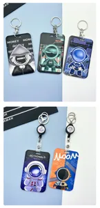Cute cartoon astronaut card holder with keychain and retractable badge reel, detail view.