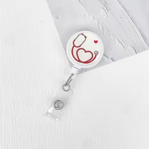 Retractable badge reel with cute red stethoscope heart design, perfect for nurses and doctors.
