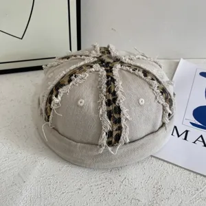 Close-up detail of the retro washed distressed docker cap featuring unique leopard print panels.
