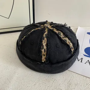 Retro washed denim miki hat with leopard patchwork design, vintage dockerman cap detail.
