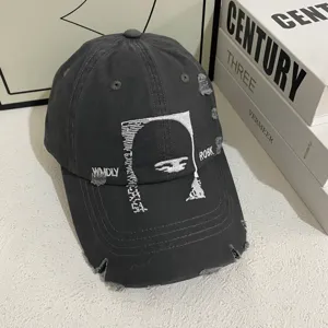 Distressed baseball cap with unique white embroidery and edgy design for trendy street wear.