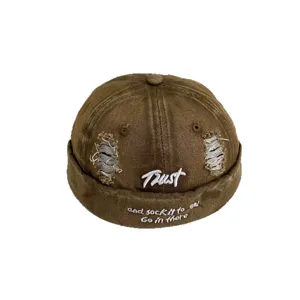 Vintage washed denim docker hat with distressed holes and custom embroidery for streetwear style.