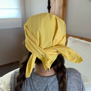 Yellow bandana cap detail view showing the neat knot and soft fabric texture for casual daily wear.