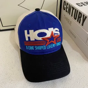 Detailed view of the colorblock baseball cap featuring stylish embroidered letters and star design.