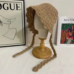 Khaki handmade crochet hollow lace-up bucket hat detail showing intricate woven pattern.